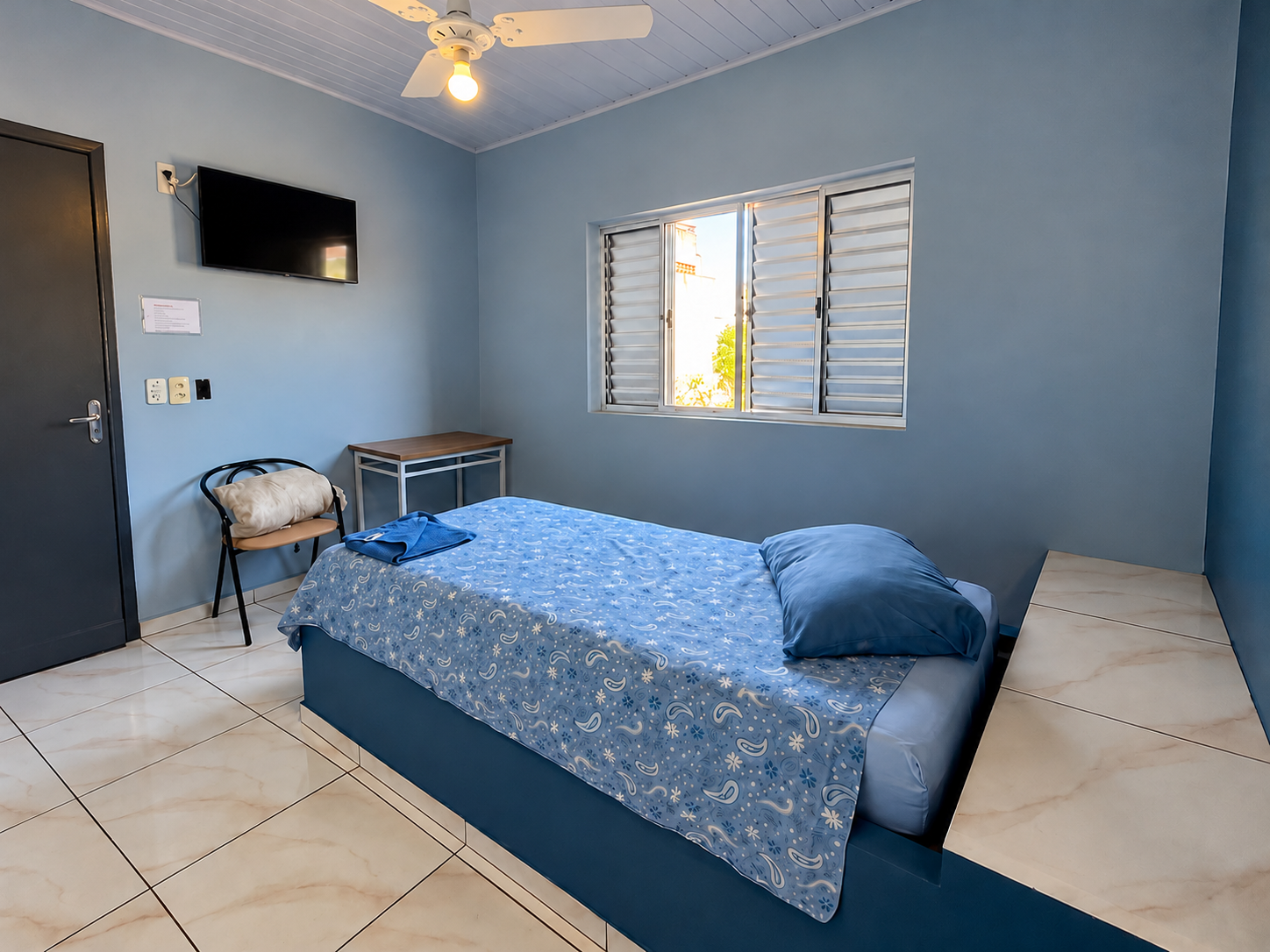 Apartamento individual com cama de solteiro e ventilador de teto no Hotel São João