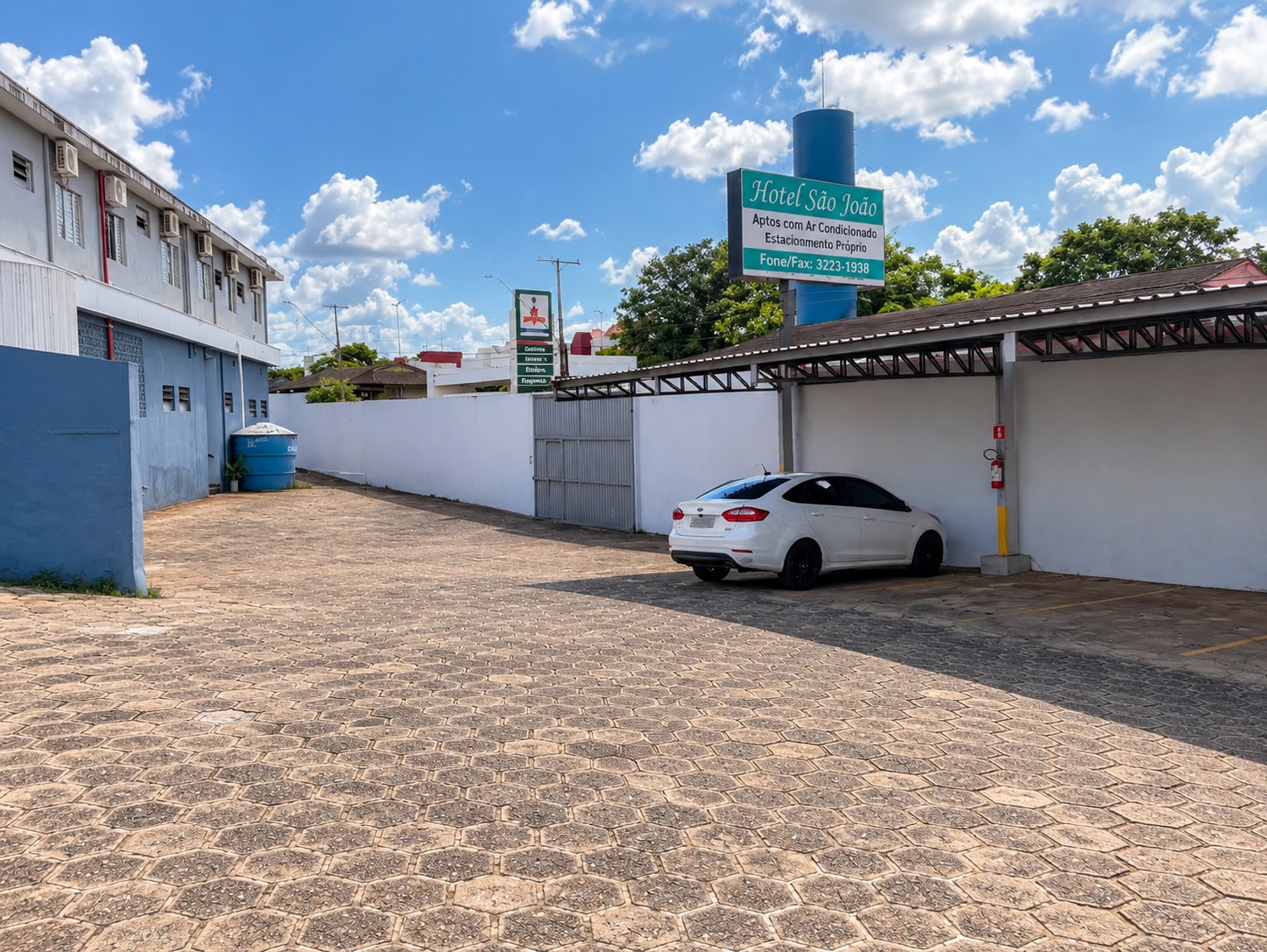 Estacionamento coberto e placa do Hotel São João